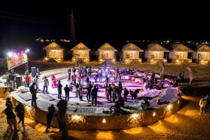 a group of people on an ice rink at night at Marawi Desert Resort in Sām