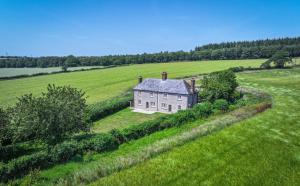 an aerial view of a house in a field at Lower Colworth Lodge in Chichester