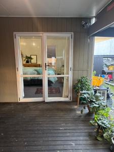 a sliding glass door on a house with a bedroom at AB Accomodation in Palmerston North
