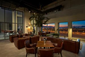 a restaurant with couches and tables and large windows at DoubleTree by Hilton Madinah Gate in Medina