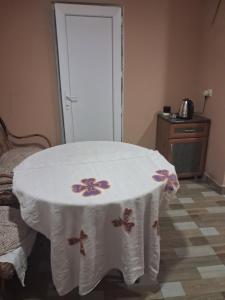 a table with a white table cloth on it in a room at Lama inn in Mestia