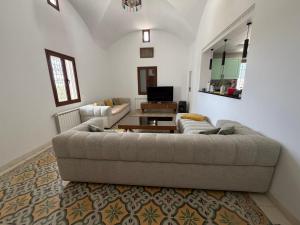 a living room with a couch and a table at Dar amiratt in El Guecheïne