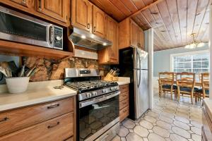 a kitchen with wooden cabinets and a stove top oven at 3664 Birch Avenue cabin in South Lake Tahoe +28 photos