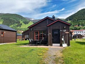a small cabin with a table and chairs in a field at Cozy Cabin with Fireplace in Åre