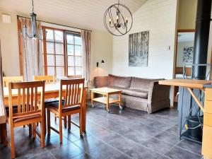a living room with a table and a couch at Cozy Cabin with Fireplace in Åre
