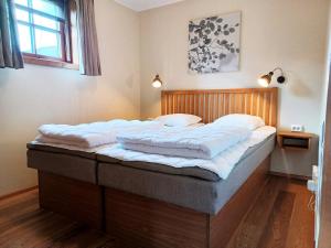 a bedroom with a large bed with white sheets at Cozy Cabin with Fireplace in Åre
