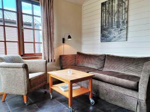 a living room with a couch and two chairs and a table at Cozy Cabin with Fireplace in Åre