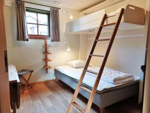 a bedroom with a bunk bed and a ladder at Cozy Cabin with Fireplace in Åre