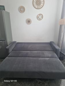 a bed in a room with a couch at Studio u Arka in Kłodzko