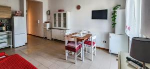 a small kitchen with a table and a refrigerator at Casa delle Farfalle in Cariati