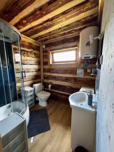a bathroom with two sinks and a toilet in a log cabin at Rancho-Bierna in Bierna +88 photos