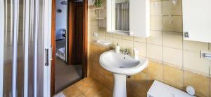 a bathroom with a white sink and a mirror at Casa delle Farfalle in Cariati +24 photos
