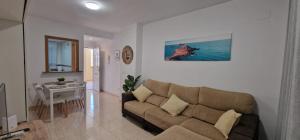 a living room with a couch and a table at Vistamar -primera linea de playa in El Borseral