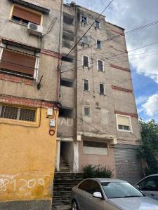 a building with a car parked in front of it at Apartament 33 in Elbasan