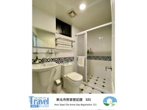 a white bathroom with a toilet and a sink at Lucky House B&B in Jiufen +30 photos