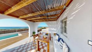 a dining room with a table and a view of the ocean at Okto in Archangelos