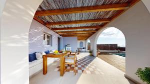 a dining room with a table and a view of the ocean at Okto in Archangelos