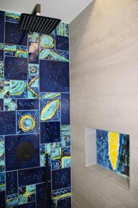 a bathroom with a mosaic tile wall with planets at Frida Luxury B&B in Vietri sul Mare +16 photos