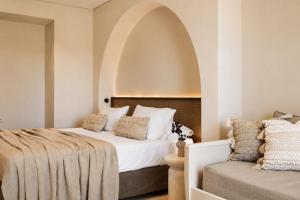 a bedroom with a bed and a chair in it at Ilios Hotel, Adults Only in Laganas