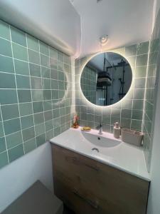 a bathroom with a sink and a mirror at Maison La Petite Pause in Bray-Dunes +22 photos