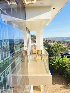 a balcony of a house with a view of the city at His Goodness - Apt Two! in Kampala