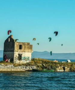 a group of kites flying in the sky over the water at Christina in Otok
