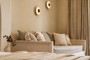 a bedroom with a bed with pillows on it at Ilios Hotel, Adults Only in Laganas +23 photos