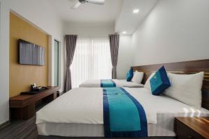 a hotel room with two beds and a window at Sunrise Villa BT09-A02 Vlasta Sam Son in Trương Tần +31 photos