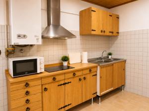 a kitchen with a microwave and a sink at Varese City Center BnB in Varese