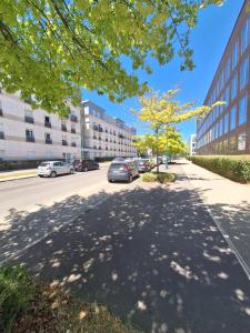 a street with cars parked on the side of a building at Studio ALPHA - non-smoking studio - 3min by train to Disney OR 30min walk - 5min walk to "Val d'Europe" train station in Montévrain