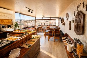a restaurant with a buffet line with food on display at Cappadocia Divin House in Göreme