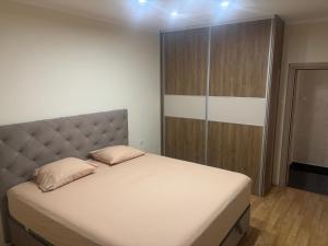 a bedroom with a bed and a wooden cabinet at SARA in Ðuranovići