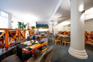 a restaurant with tables and chairs in a room at Gooderson Tropicana Hotel in Durban +70 photos