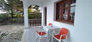 a table and chairs on a patio with a window at Vigla in Spartià