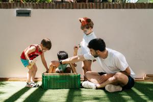 a man sitting on the floor with two children playing with toys at Smy Isla Cristina in Isla Cristina +113 photos