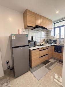 a kitchen with a refrigerator in the middle of it at Rama Stays in Nairobi