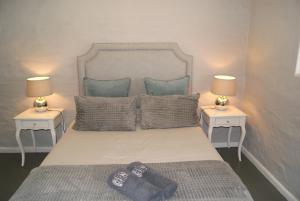 a bedroom with a large bed with two night stands at Chalet Eland in Ladismith