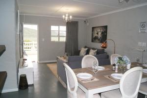 a living room with a table and a couch at Chalet Eland in Ladismith