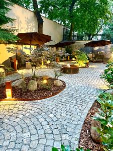 a stone patio with umbrellas in front of a building at Alfons Boutique Hotel in Prague