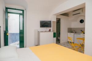 a kitchen with a yellow table in a room at Casetta Puntino in Atrani
