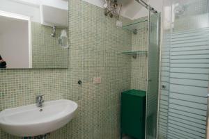 a bathroom with a sink and a glass shower at Casetta Puntino in Atrani