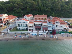 an aerial view of a large house on the water at Val beach apartment in Nea Potidaea +5 photos