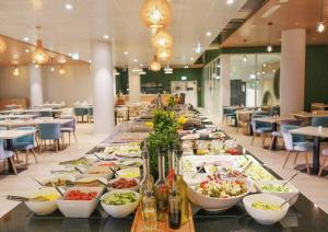 a long buffet of food on a table in a restaurant at PINEA Resort in Pobierowo