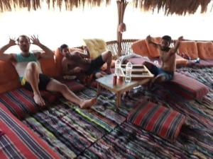 a group of men laying on a couch at La Basha Camp in Dahab