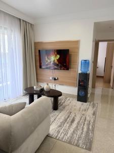 a living room with a couch and a table at Rama Stays in Nairobi