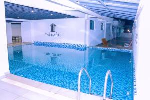 a large swimming pool with a sign that reads the lite court at Rama Stays in Nairobi