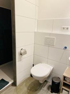 a white bathroom with a toilet and a sink at Wöllbacher Tor in Wetzlar