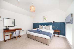 a bedroom with a bed and a desk and a computer at Shore Hotel in Balintore