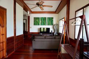 a living room with a couch and a tv at The Hill Village in Thong Nai Pan Noi
