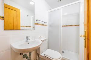 a white bathroom with a sink and a toilet at Ferrera Soul 2a in Felanitx